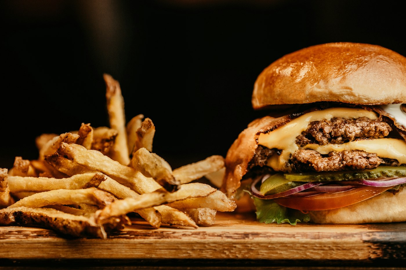 Burger and fries on a wooden board