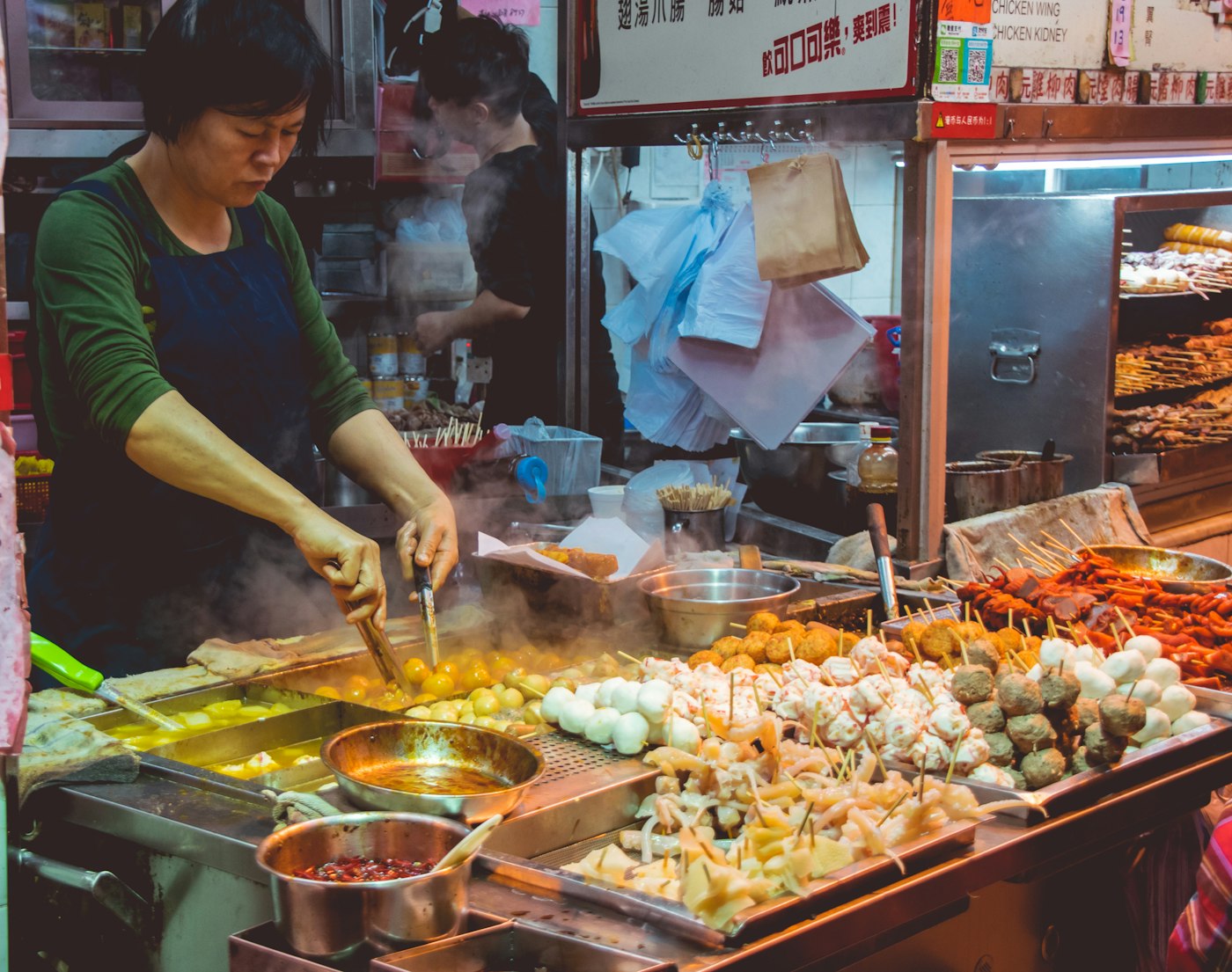 Cook working a street-food counter