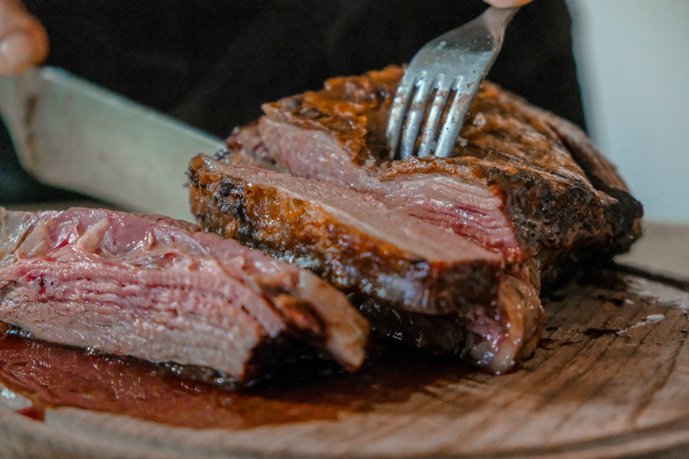 Sliced herb-crusted tenderloin with rosemary on a board