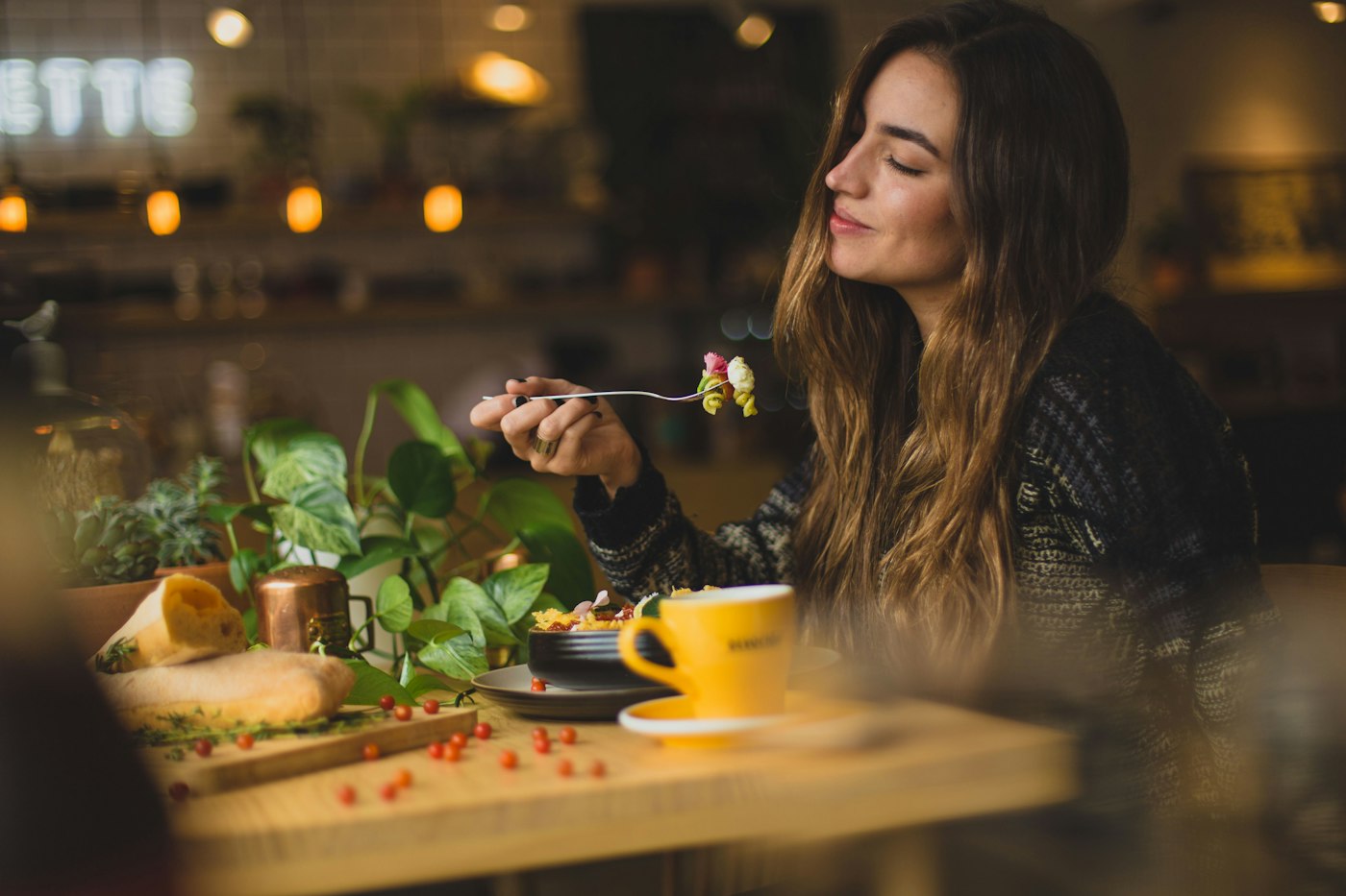 A guest enjoying a dish in warm light