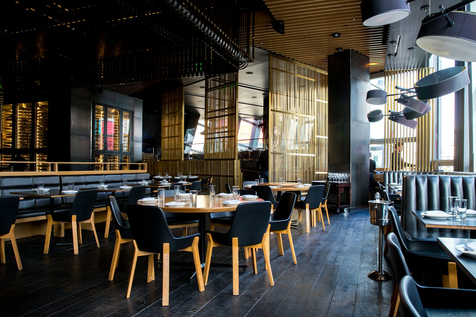 The dark, modern dining room with leather chairs
