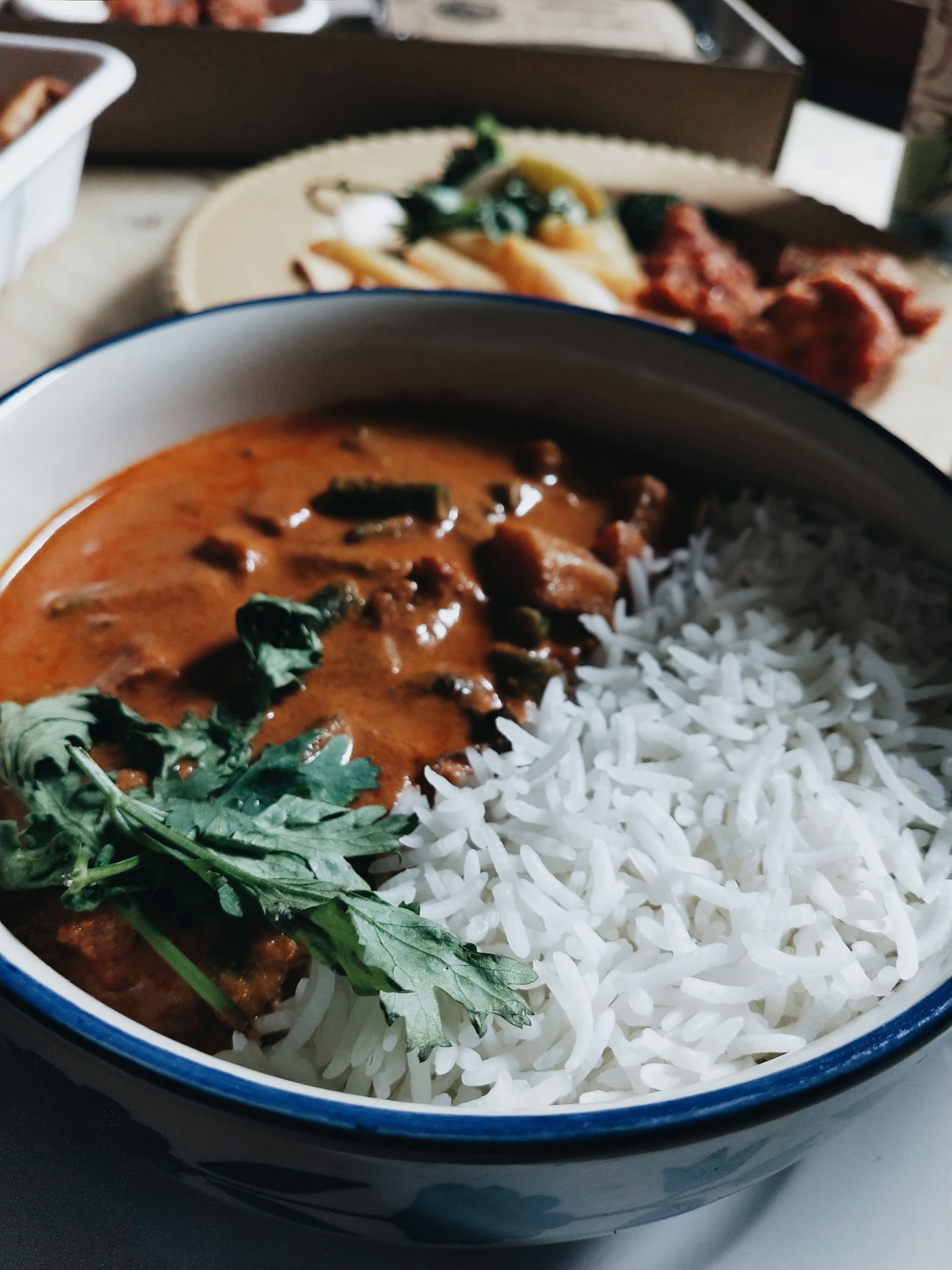 Dark, pepper-heavy Chettinad curry beside steamed rice