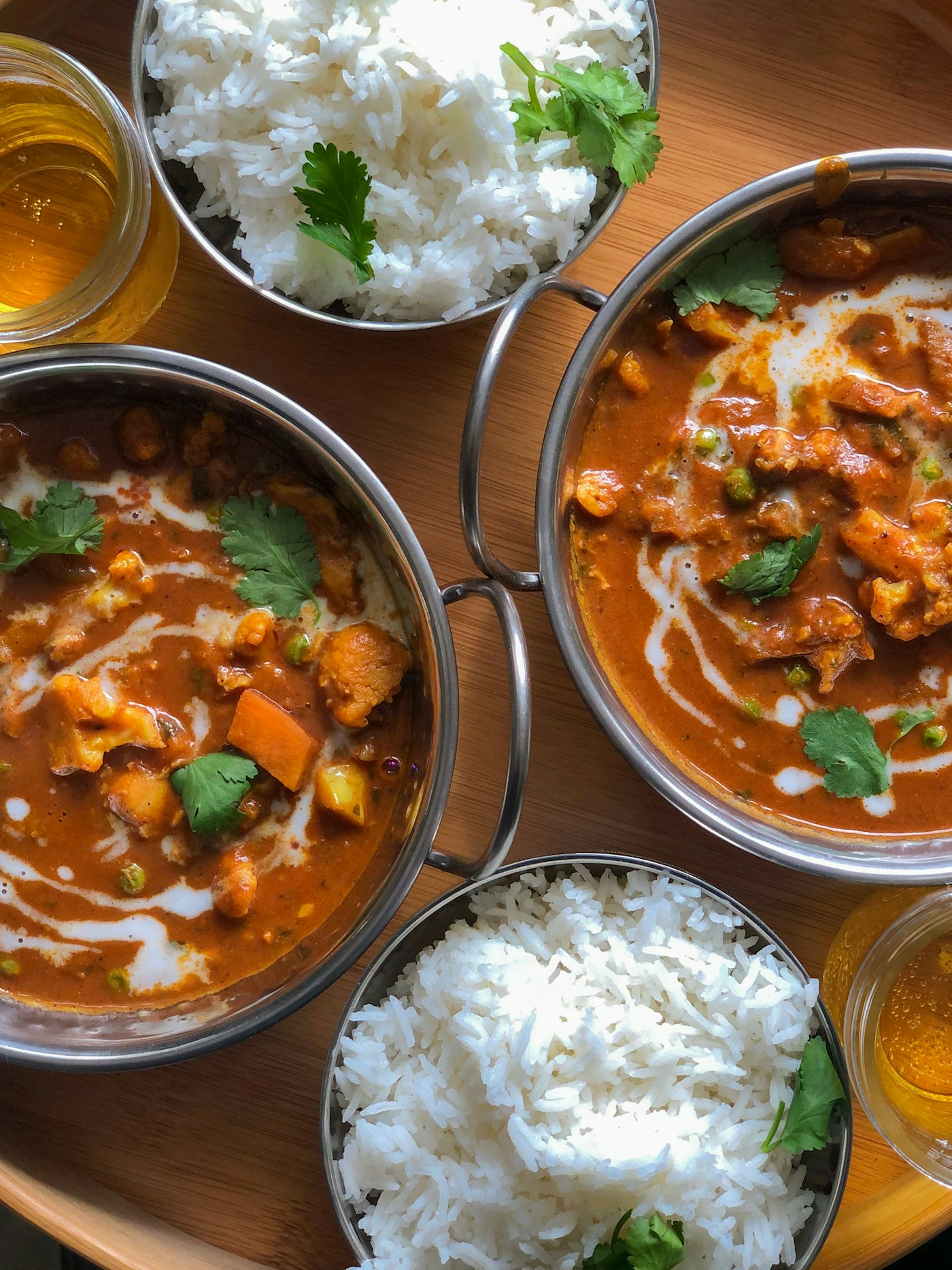 Assorted curries in small bowls