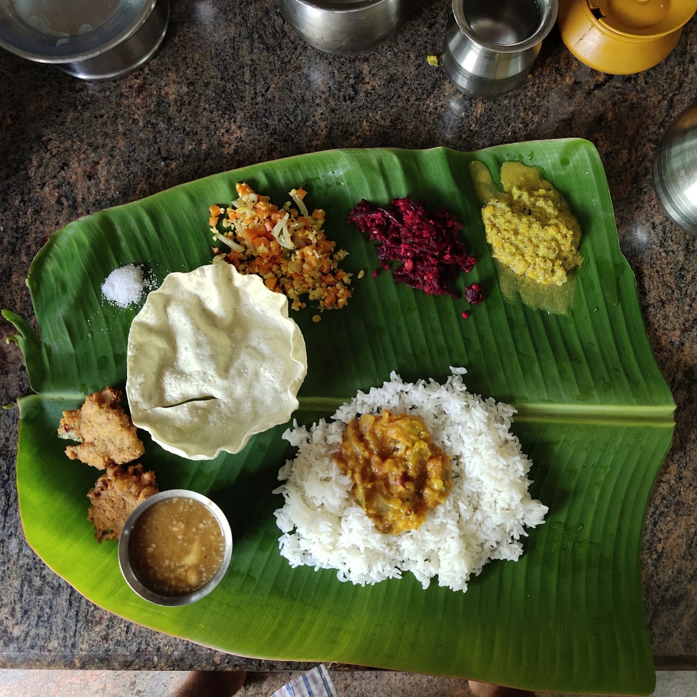 A festive meal laid on a banana leaf
