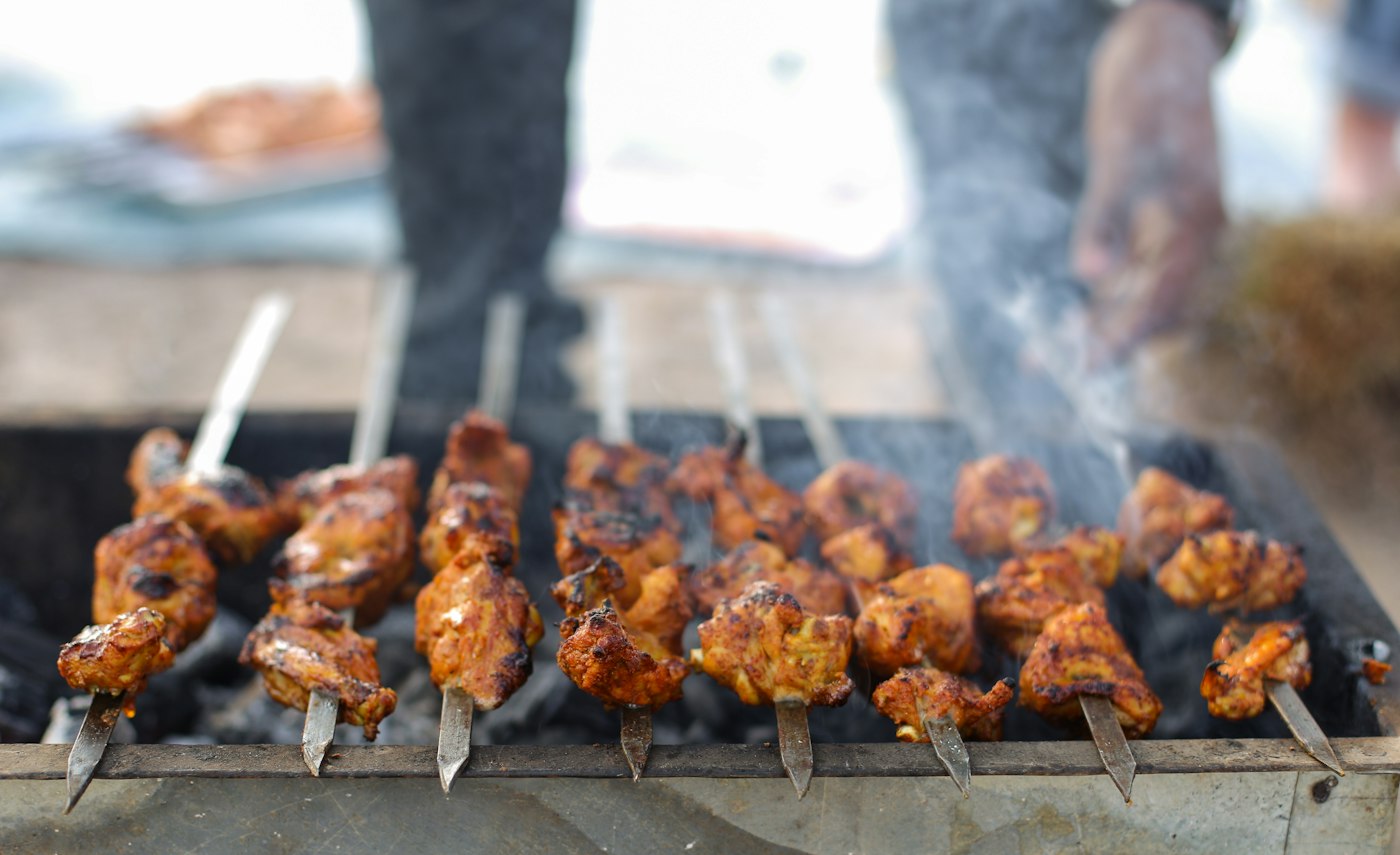 Skewers grilling over coals
